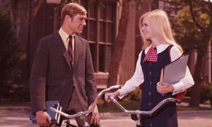 1960s Ivy League students girl and boy talking
